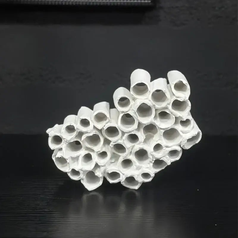 Abstract white ceramic honeycomb mesh conduit sculpture composed of interconnected cylindrical tubes for living room decor