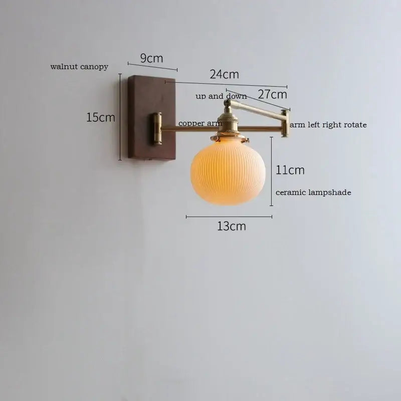 Adjustable brass wall sconce with warm-toned ribbed ceramic lampshade and copper arm for bedroom lighting decorbites copper arm