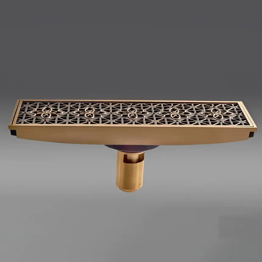 Antique brass carved floor drain cover with intricate geometric cutout pattern for bathroom use