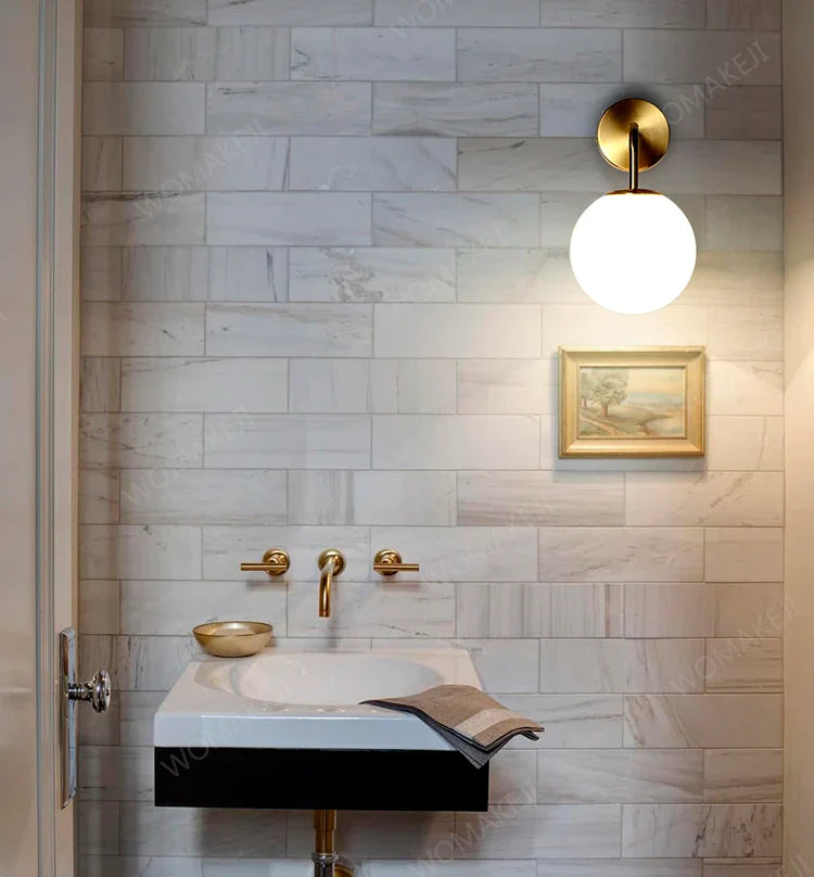 Bathroom sink with gold fixtures.