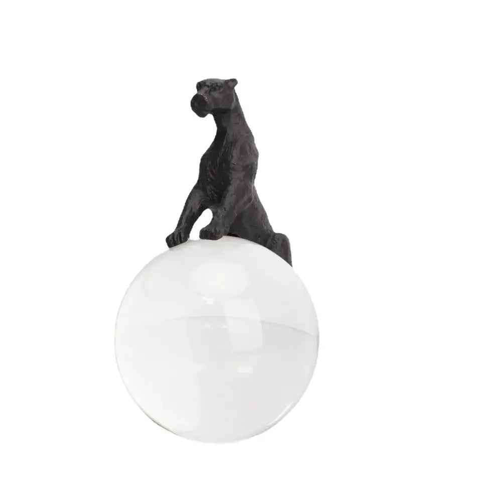 Black matte-finished panther figurine perched on clear glass sphere crystal ball metal animal decorbites living room decor