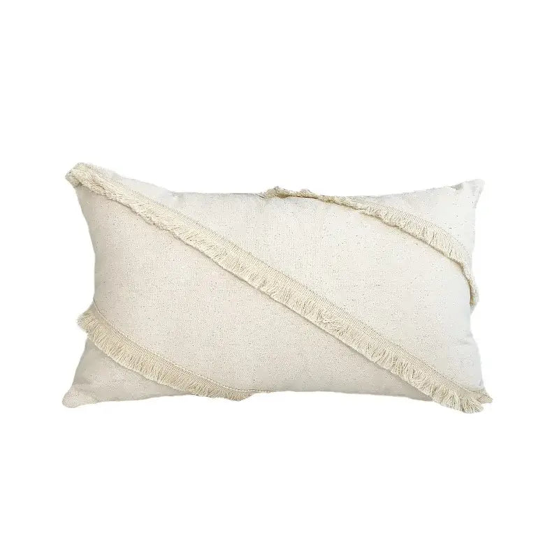 Cream-colored rectangular cushion cover with lace floral design and diagonal fringed fabric strips for decorbites boho white decor