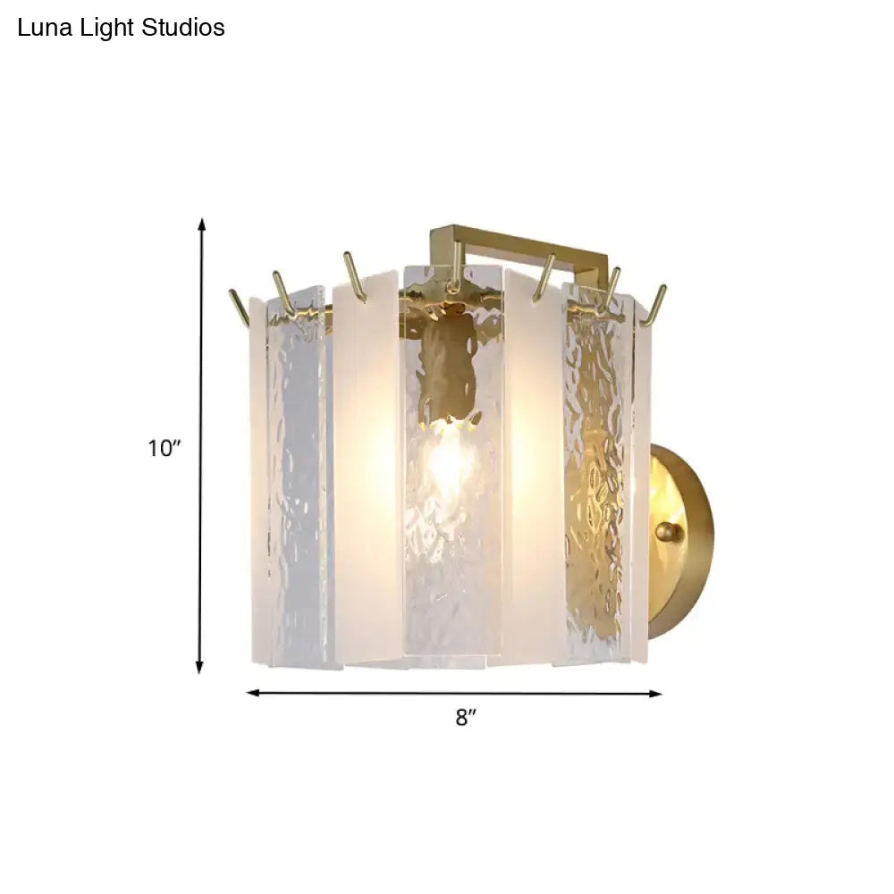 Contemporary gold drum wall sconce light with textured translucent white glass panels in a rectangular frame for bedroom
