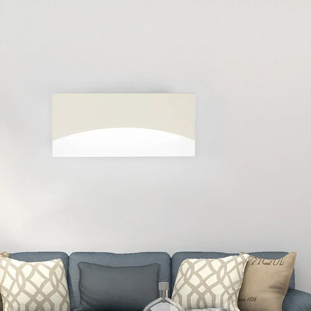 Contemporary white and gold bedroom sconce with beige and white abstract rectangular wall art featuring curved design and warm color temperature