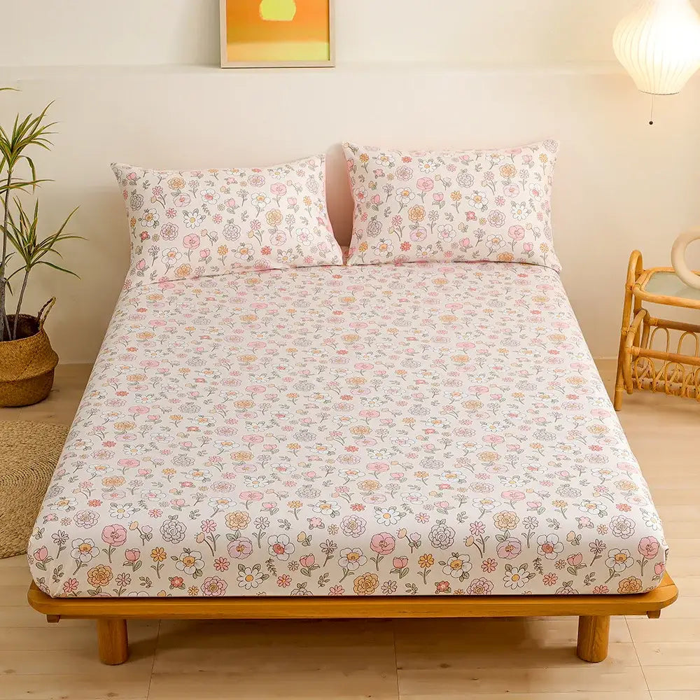 Pastel floral fitted sheet set with pink, yellow blossoms and green leaf flower on soft white background for bedroom bedding