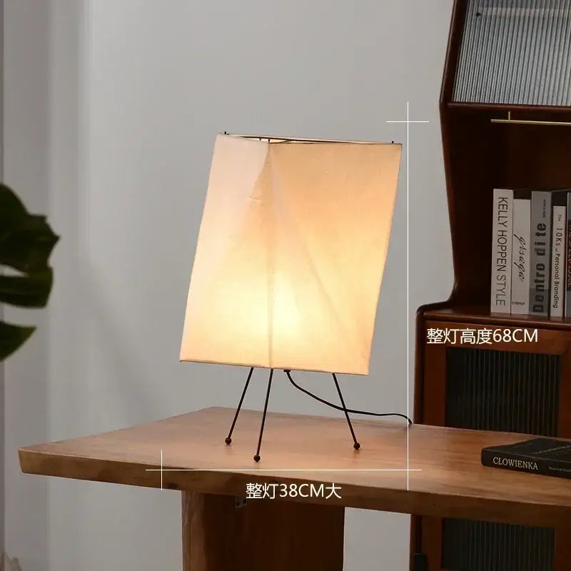 DecorBites Akari rice paper floor lamp with warm-toned rectangular shade and minimalist black metal tripod base