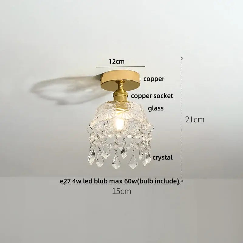 A delicate crystal chandelier with brass copper base and glass housing featuring clear crystals for amber glass led ceiling light