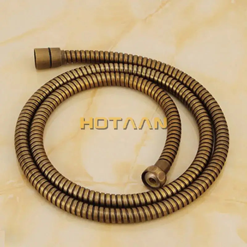 Antique brass handheld bidet sprayer set with flexible spiral brass-colored hose and threaded connectors for bathroom use