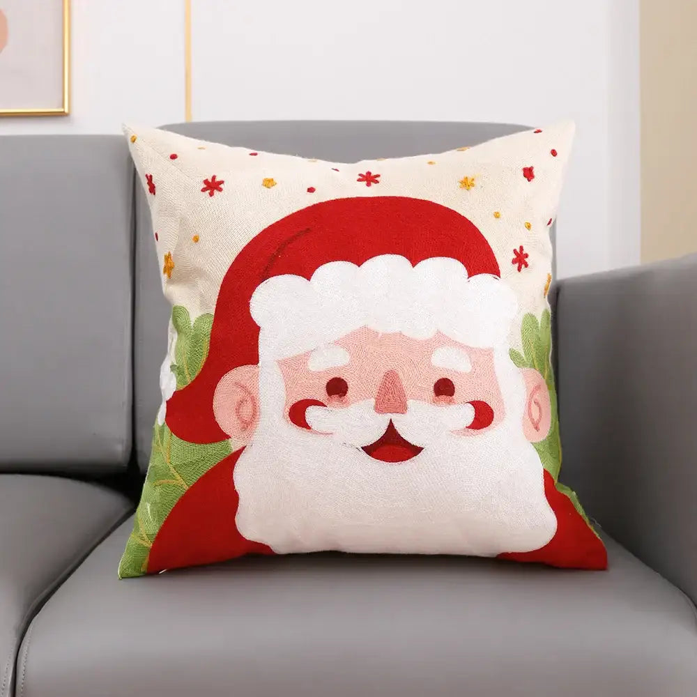 Cream-colored cotton decorbites christmas embroidery cushion cover with smiling santa and festive green foliage patterns