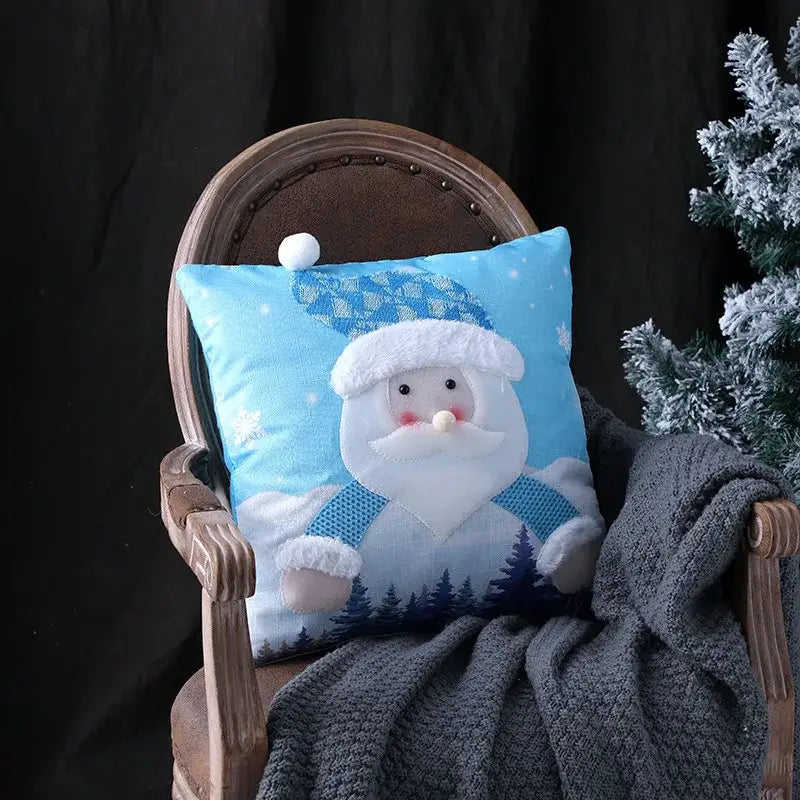 Blue plush pillow cover featuring smiling santa with embroidered snowflake decorbites christmas patchwork design