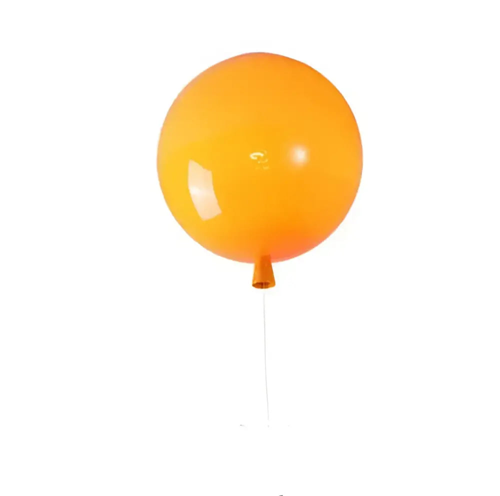 A bright orange glossy balloon wall lamp with a thin string from decorbites colorful balloon memory led collection