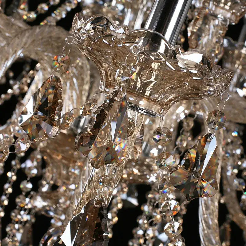 A decorbites crystal chandelier with faceted amber and clear glass elements on a polished chrome fixture for bedroom lighting