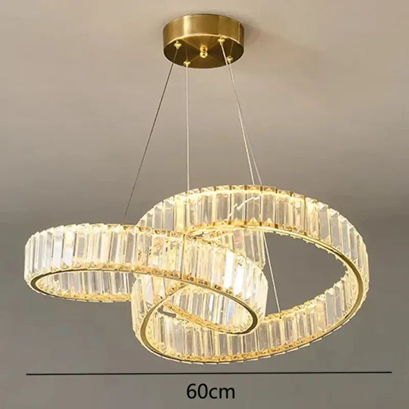 Gold-toned double-ring decorbites crystal chandelier with clear crystal facets and integrated led lighting for modern living rooms