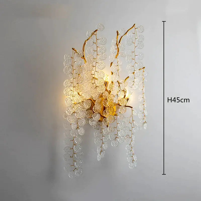 Gold-toned decorbites crystal led wall sconce with clear crystal discs resembling a delicate branch for dining room lighting