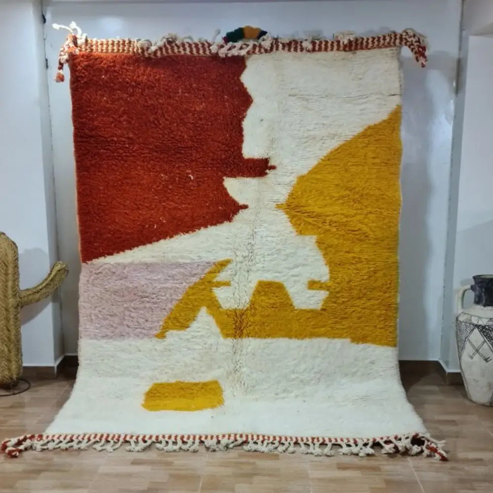 Vibrant chunky-knitted moroccan handmade beni ouarain rug with bold geometric patterns in rust cream mustard and blush pink