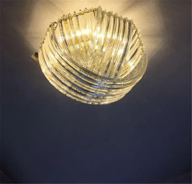 Elegant gold glass tube pendant chandelier with a clear twisted glass tube and warm glow for dining room lighting