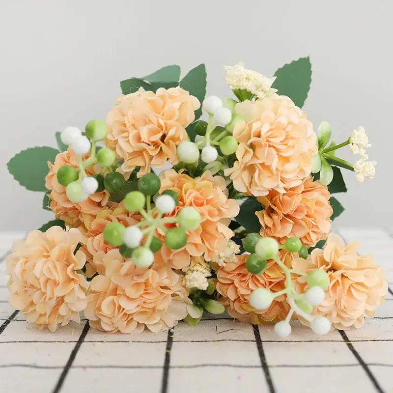 Elegant pink hydrangea decorbites daisy bouquet with peach-colored artificial flowers and green and white berries for decor