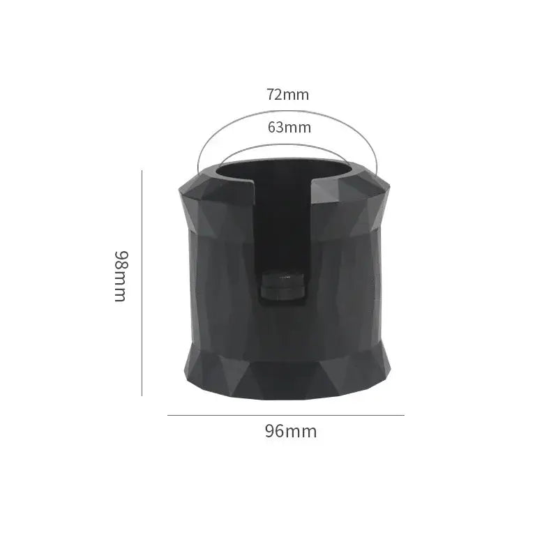 Faceted matte black metal espresso portafilter holder with central slot and dimensions 98mm tall by 96mm wide base