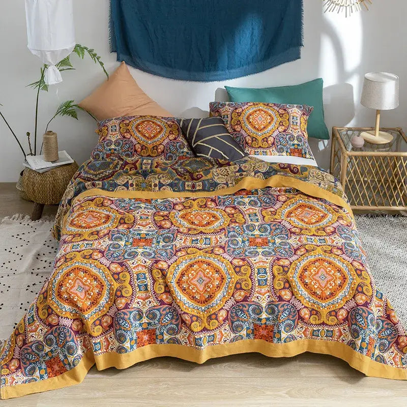 Vibrant orange and blue geometric-patterned cotton gauze towel blanket with mustard-yellow border from decorbites cotton gauze collection