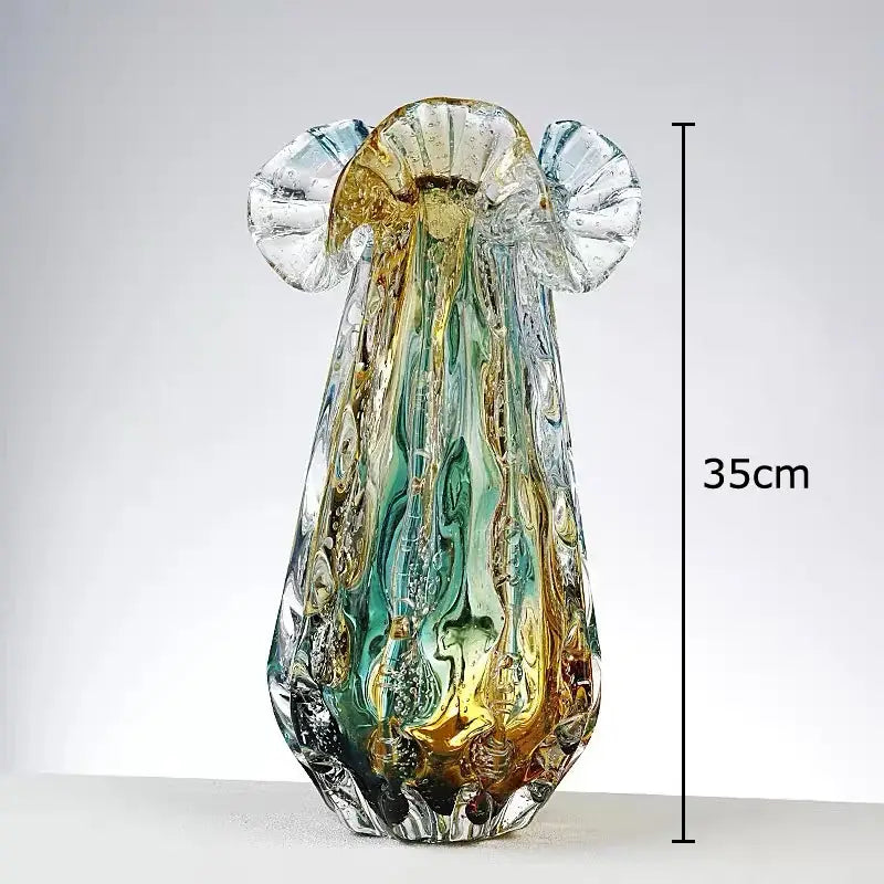 A 35cm tall translucent glass sculpture with colorful flower edge wings in green gold and amber tones