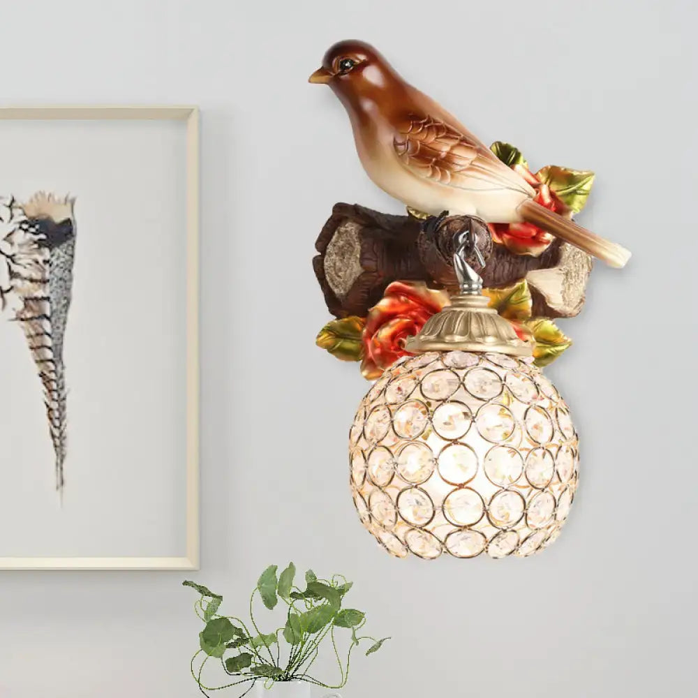 Lodge brown and cream bird wall sconce with painted flowers and ornate crystal global shade for bedroom use