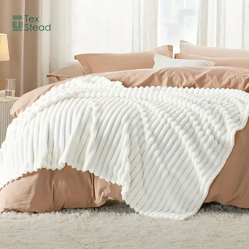 Luxe ribbed white flannel throw blanket with textured pattern and soft fluffy edges for bedroom plush decor