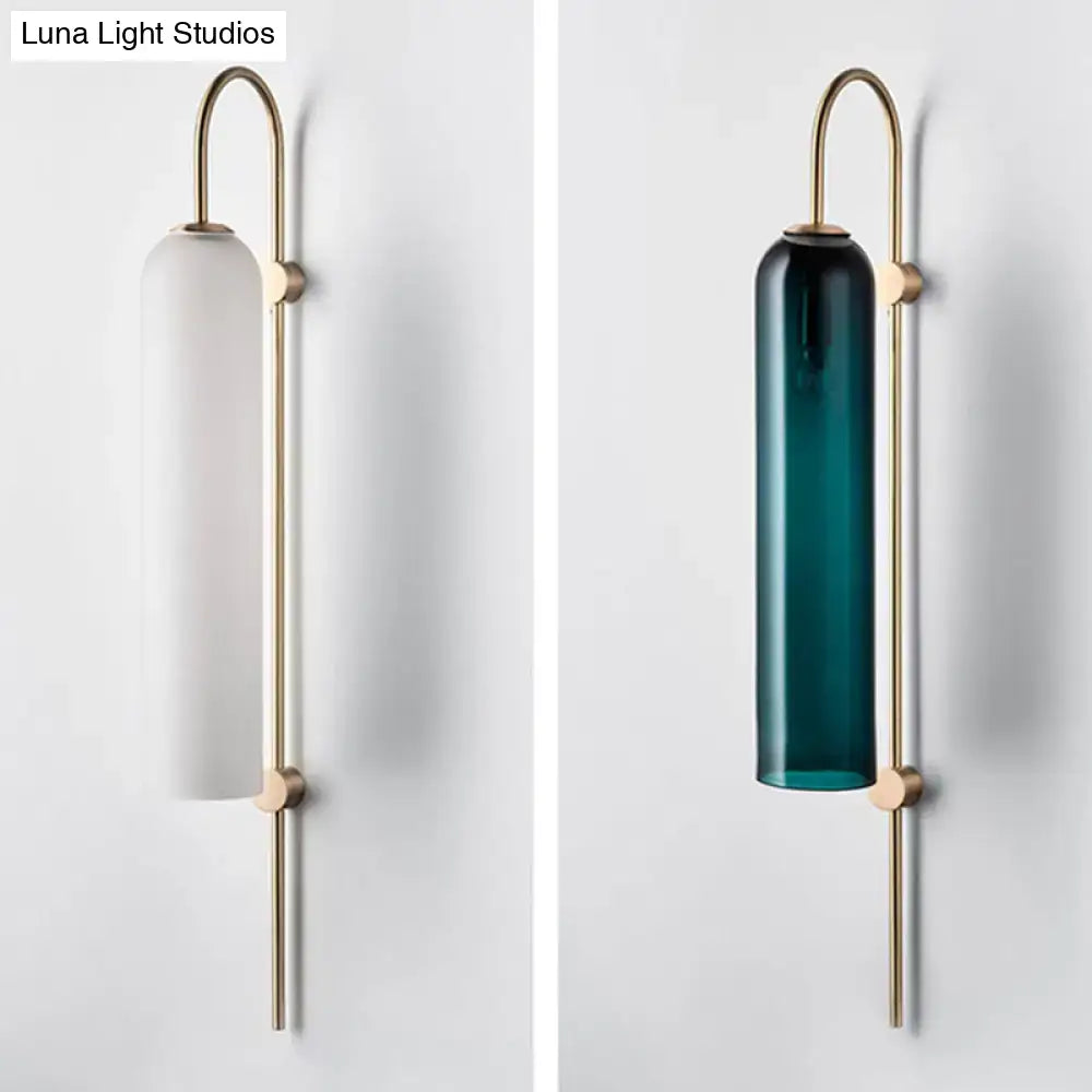 Modern mid century gooseneck wall light with a slender brass frame and frosted white or deep teal glass shade