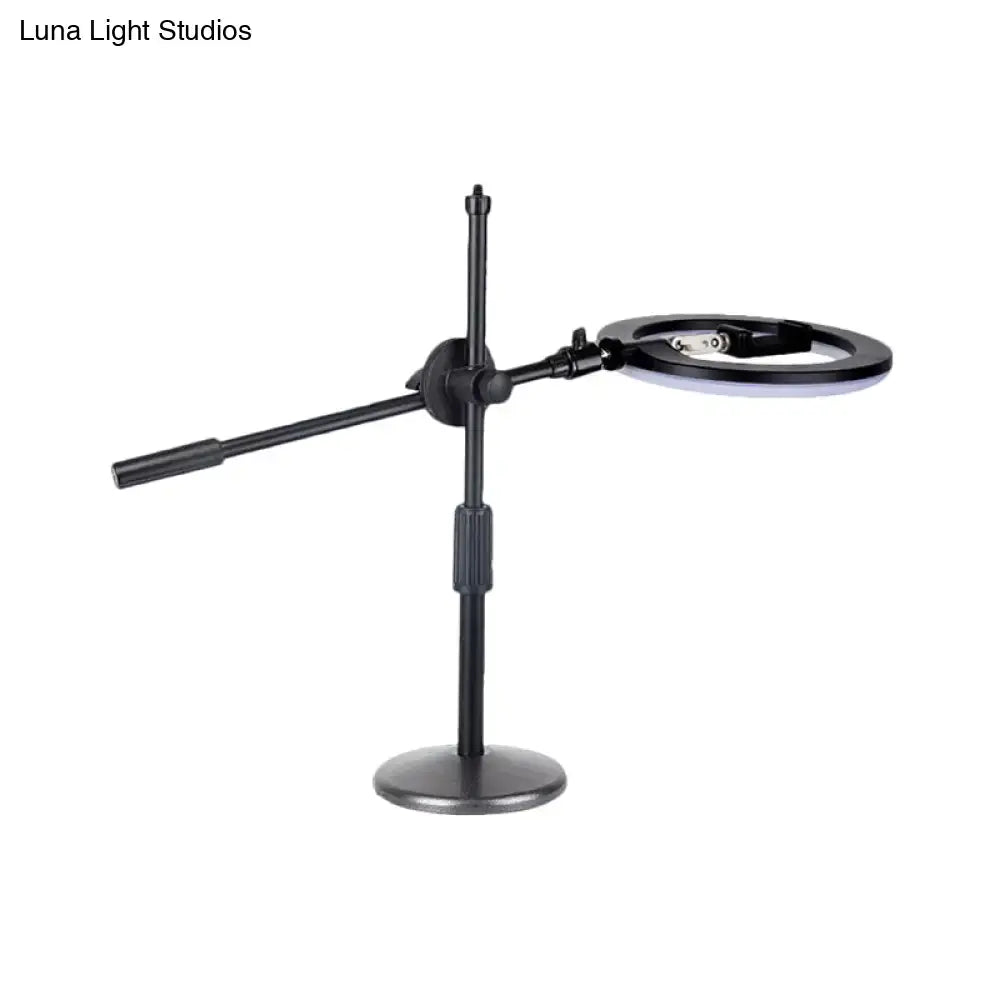 Minimalist black finish led ring light with magnifying glass and phone holder on articulated stand for bedroom vanity