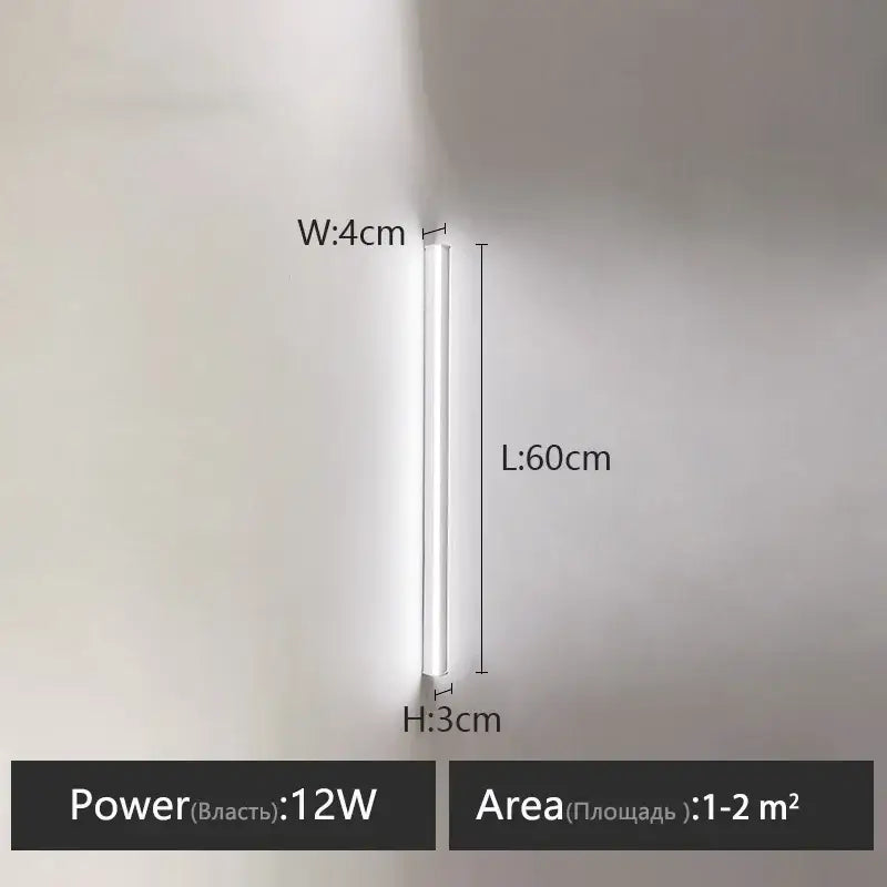 A sleek white 12w led wall lamp with slim cylindrical design ideal as a bedroom wall lamp for warm glow lighting