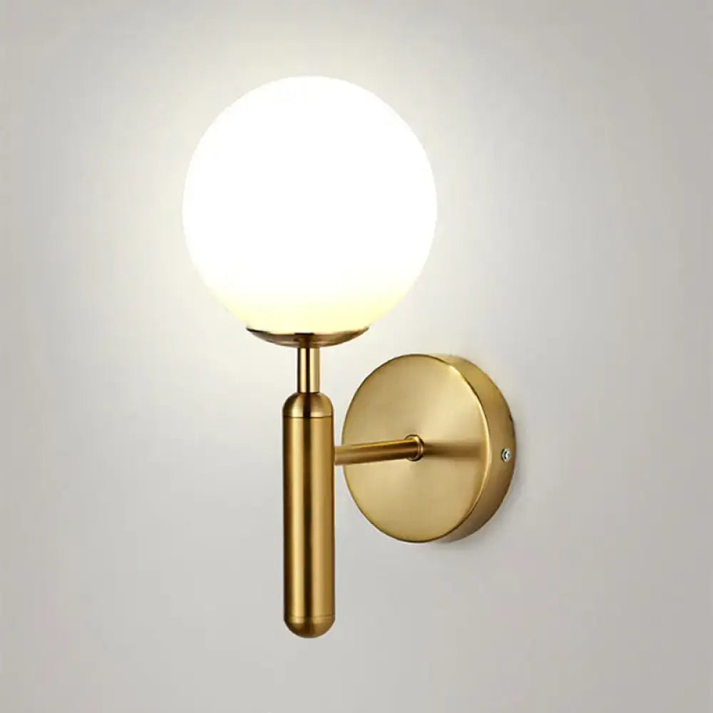 A minimalist brass textured glass globe wall mount light with frosted glass globe shade for bedroom use