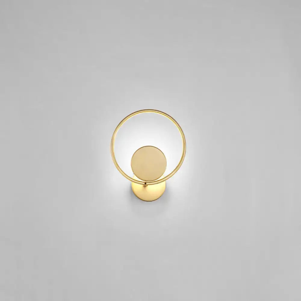 Minimalist gold metal led sconce wall mounted lamp featuring a circular ring and concentric disc design for bedroom