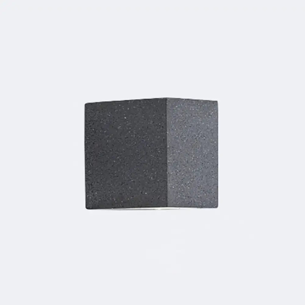 Minimalist dark gray speckled concrete cube wall sconce with led light for corridor lighting