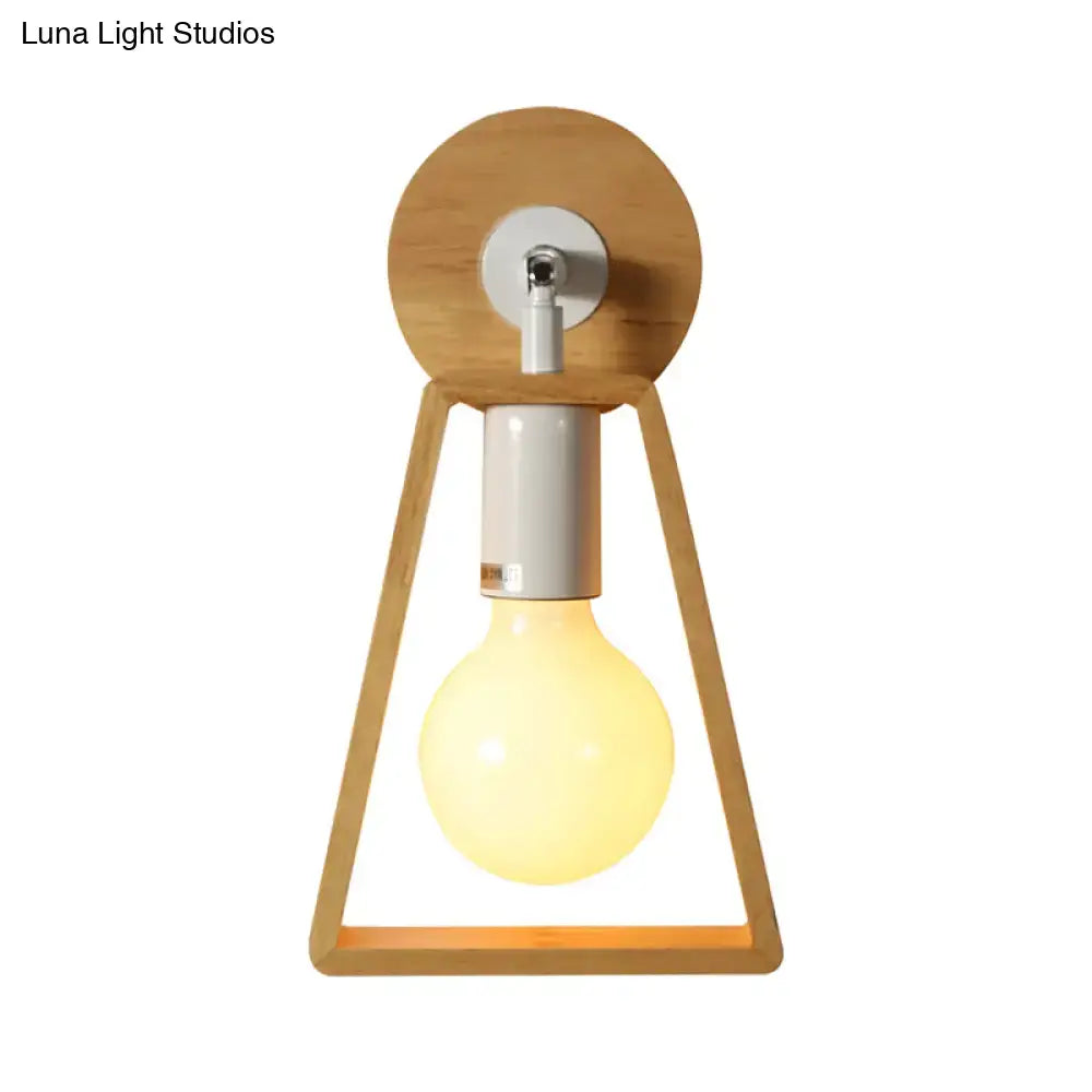 A warm-toned minimalist wall lamp with a natural wood trapezoid frame and silver metal accents for bedroom use