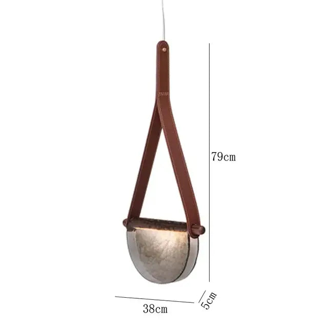 Brown leather strap suspends half-moon shaped amber and matte gray decorbites handmade glass pendant lamp