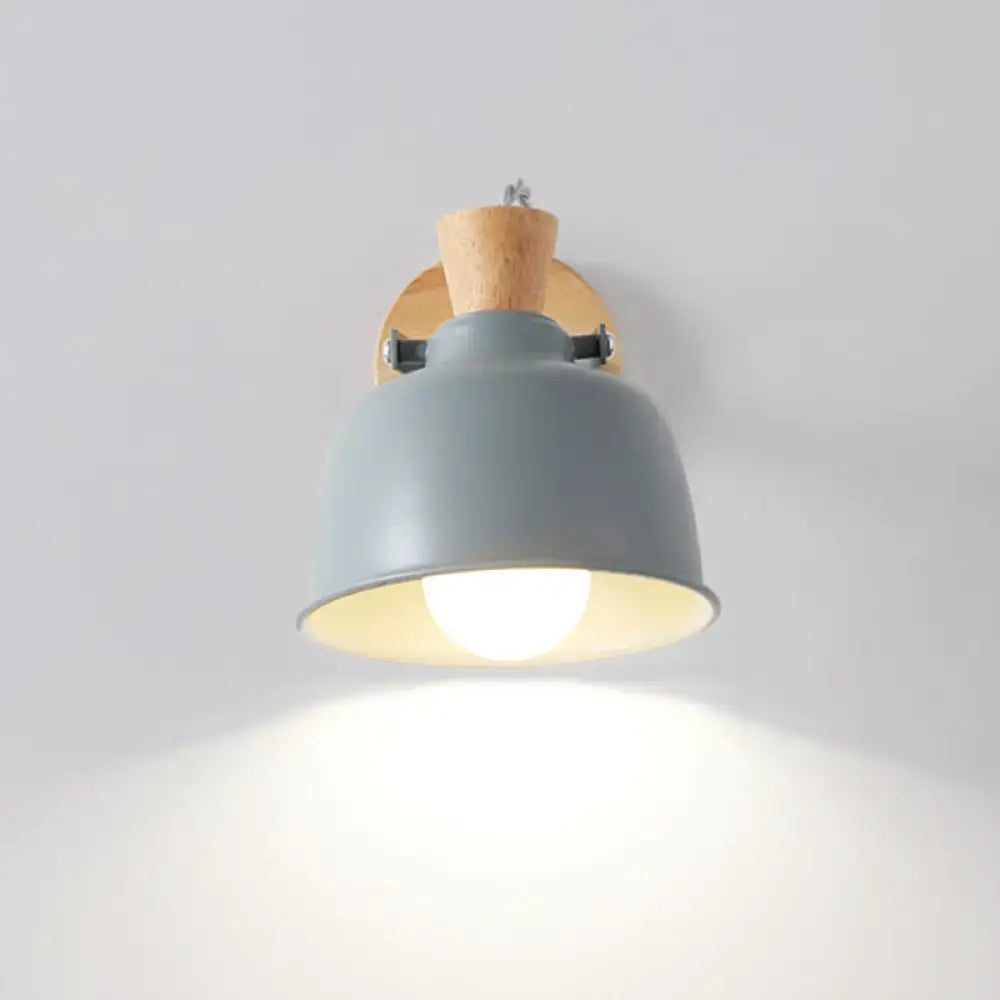 Modern black and brass metal wall light with gray metal pendant, wooden cork accent, and black mounting hardware
