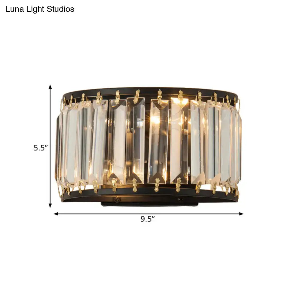 A sleek black and gold wall lamp with vertical crystal prisms for bedroom lighting fixture