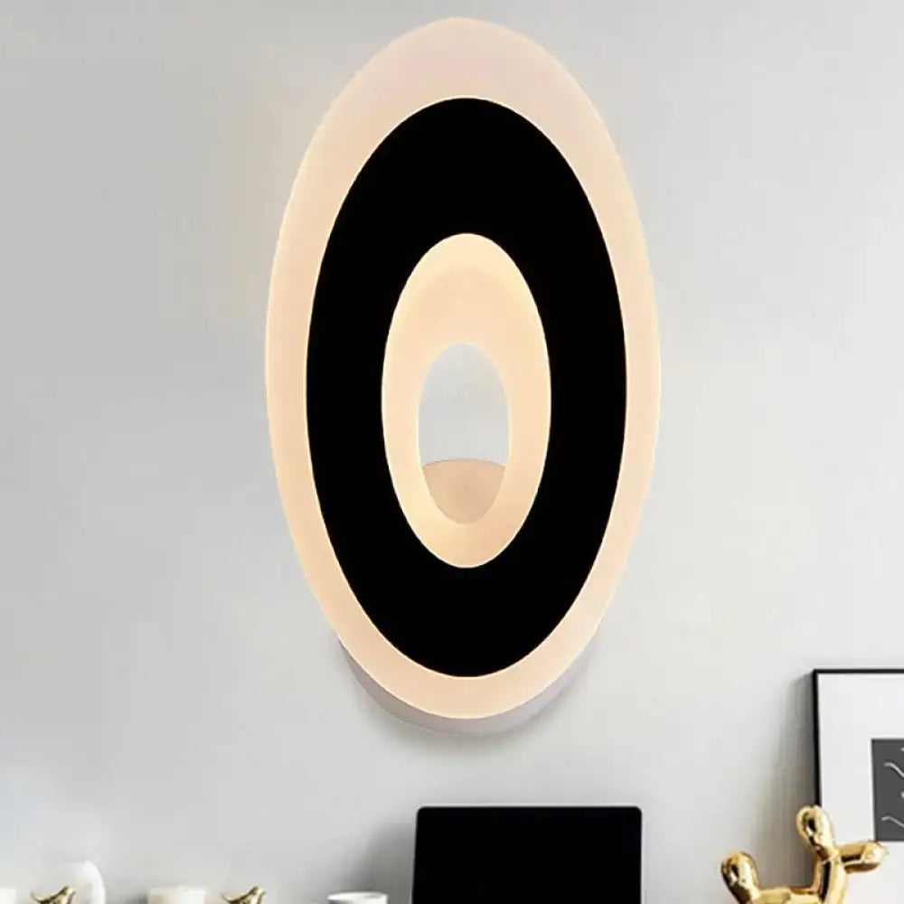 Modern black and cream oval direct wired electric wall lamp with sleek concentric ring design for bedroom light type