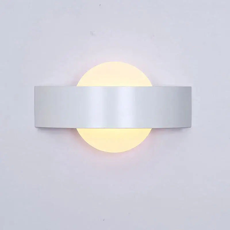 Modern black led wall lamp with frosted glass and sleek silver metallic bar featuring warm glowing circular diffuser