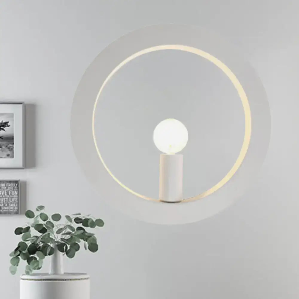 Minimalist modern black and white circle wall light with warm glowing ring and white cylindrical base for bedroom use