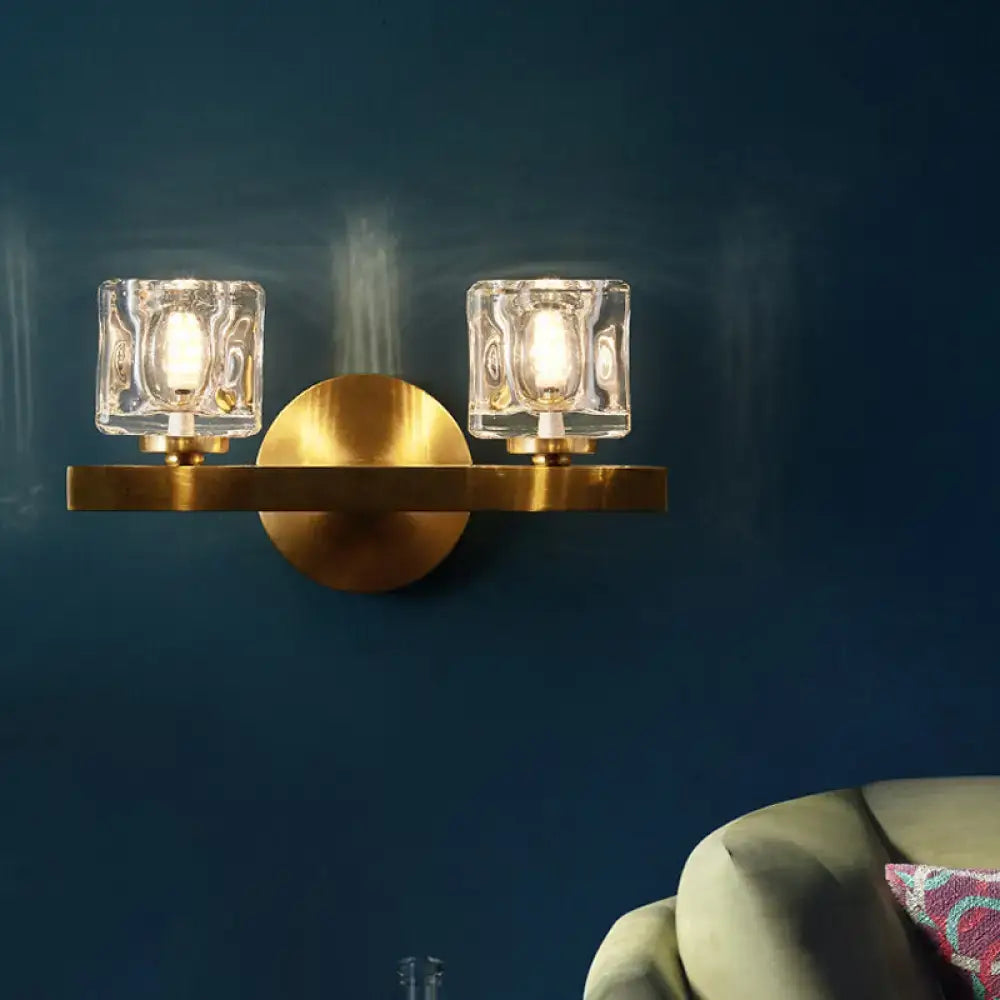 Modern brass crystal wall sconce with two clear textured glass cube shades for contemporary cube flush lighting