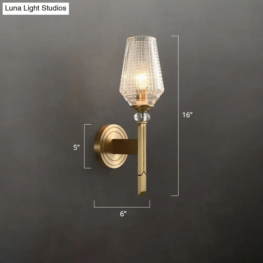 Modern brass diamond wall light with gold-toned lattice glass shade and crystal accent for bedroom lighting