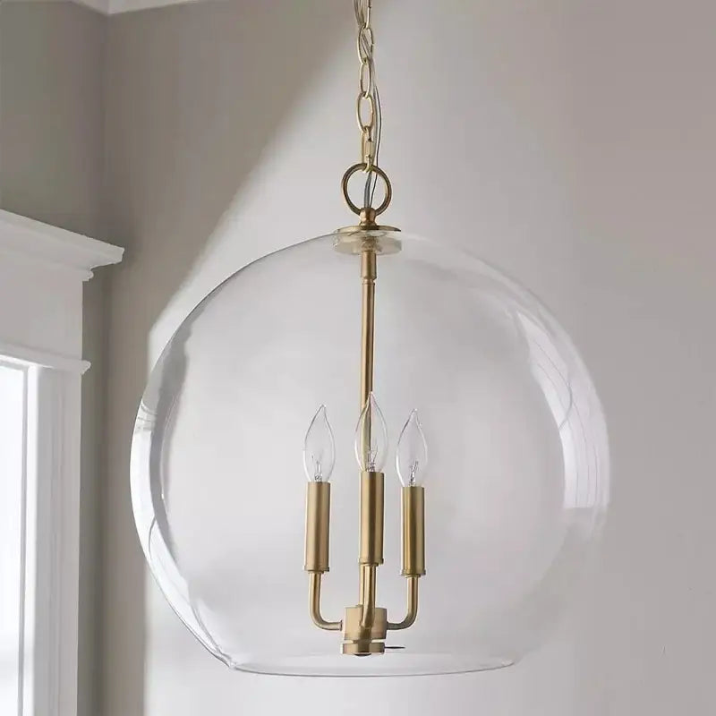 Modern brass glass ball led chandelier with clear glass dome and three candle-style bulbs for dining room decorbites glass ball