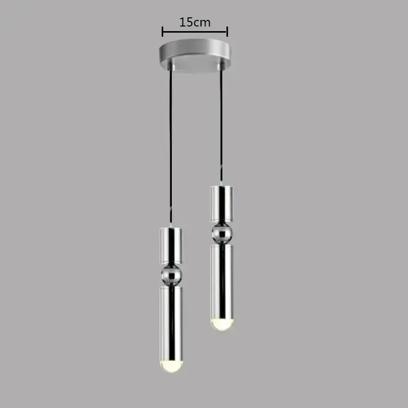 Modern chrome finished pendant light with two cylindrical bulbs and black cords in decorbites brass pendant light style