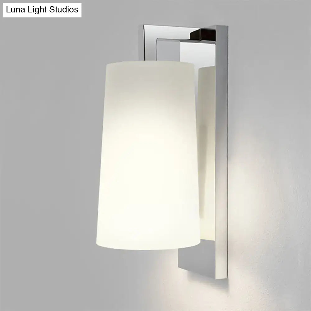 Modern chrome wall lamp with frosted white glass cylindrical shade and sleek fixture height for bedroom use