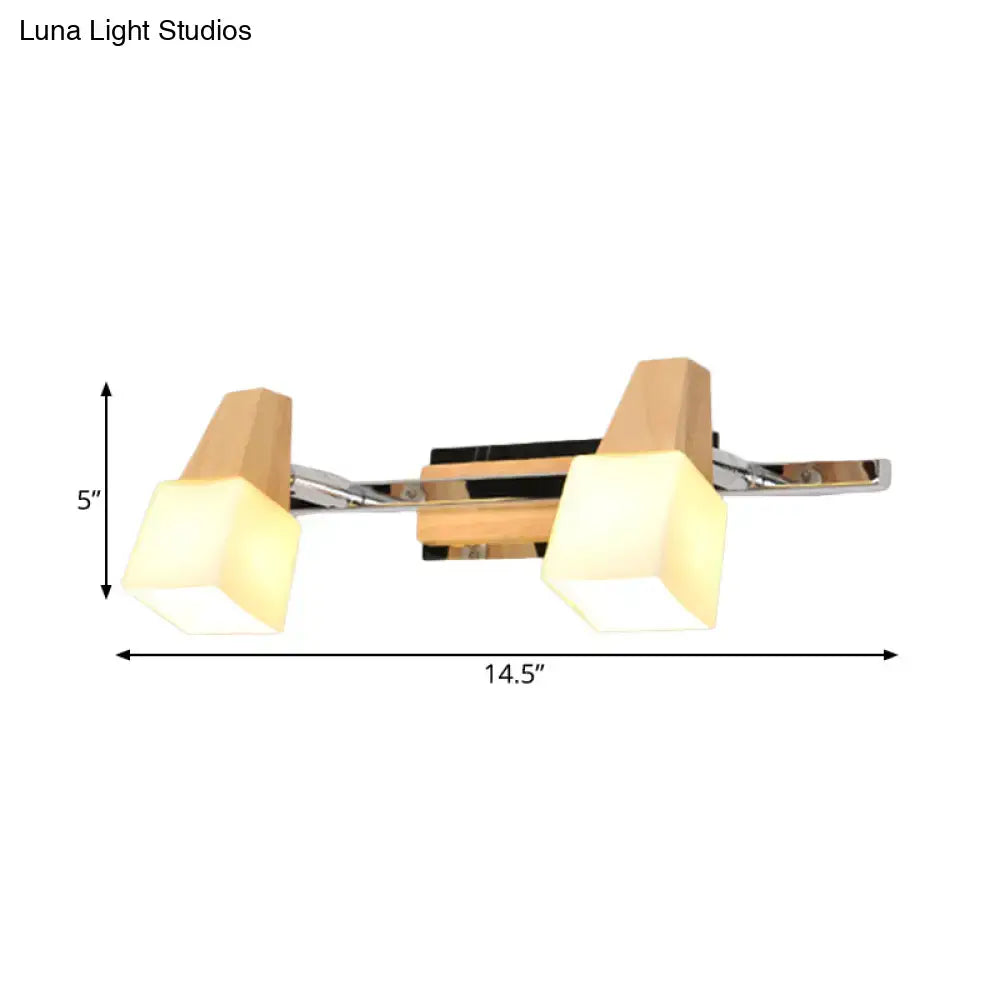 Modern chrome and wood cube vanity light fixture with warm geometric acrylic shades for bathroom lighting