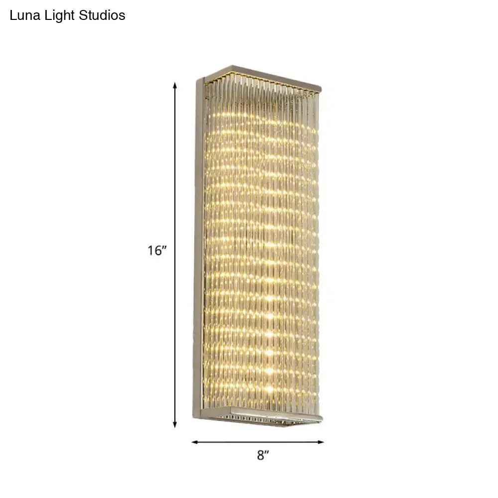 A sleek 16-inch tall modern chrome led wall sconce with crystal rods emitting warm light for living room or bar use