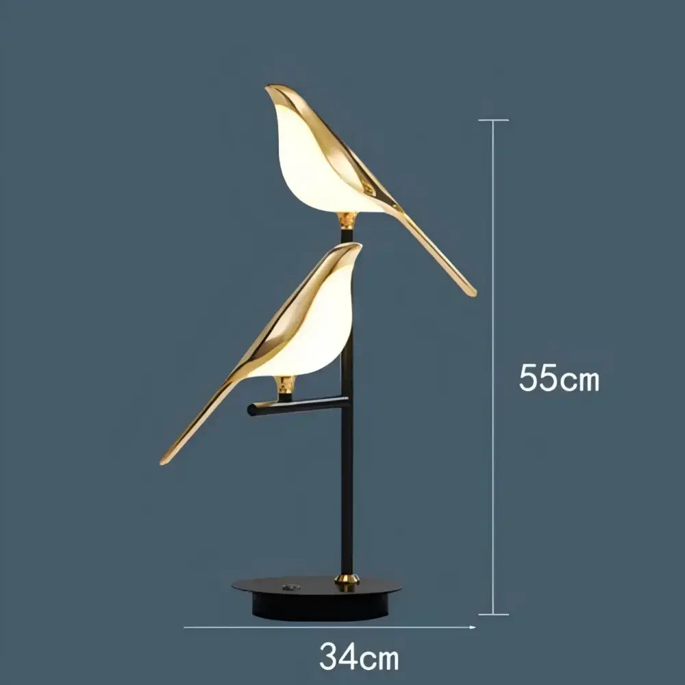 Modern gold and black magpie bird pendant light with gold-toned illuminated bodies and iron finish for dining room cord pendant installation