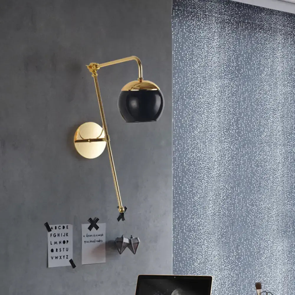 Modern gold wall sconce with adjustable arm and clear black glass spherical lampshade for bedroom lighting