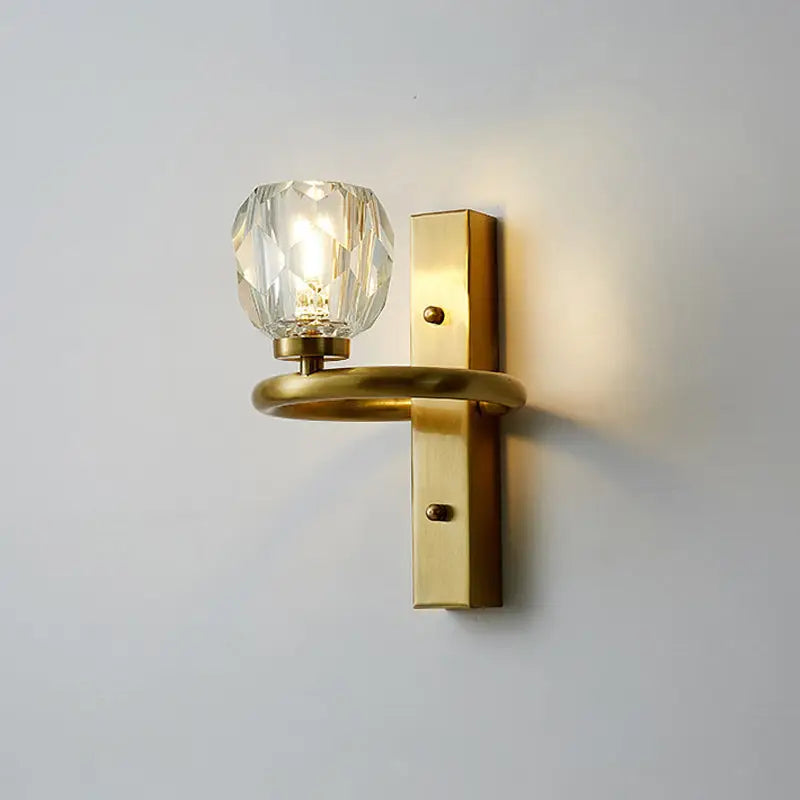 A modern gold brass wall lamp featuring a faceted crystal globe bulb compatible with 110v-120v and 220v-240v voltage