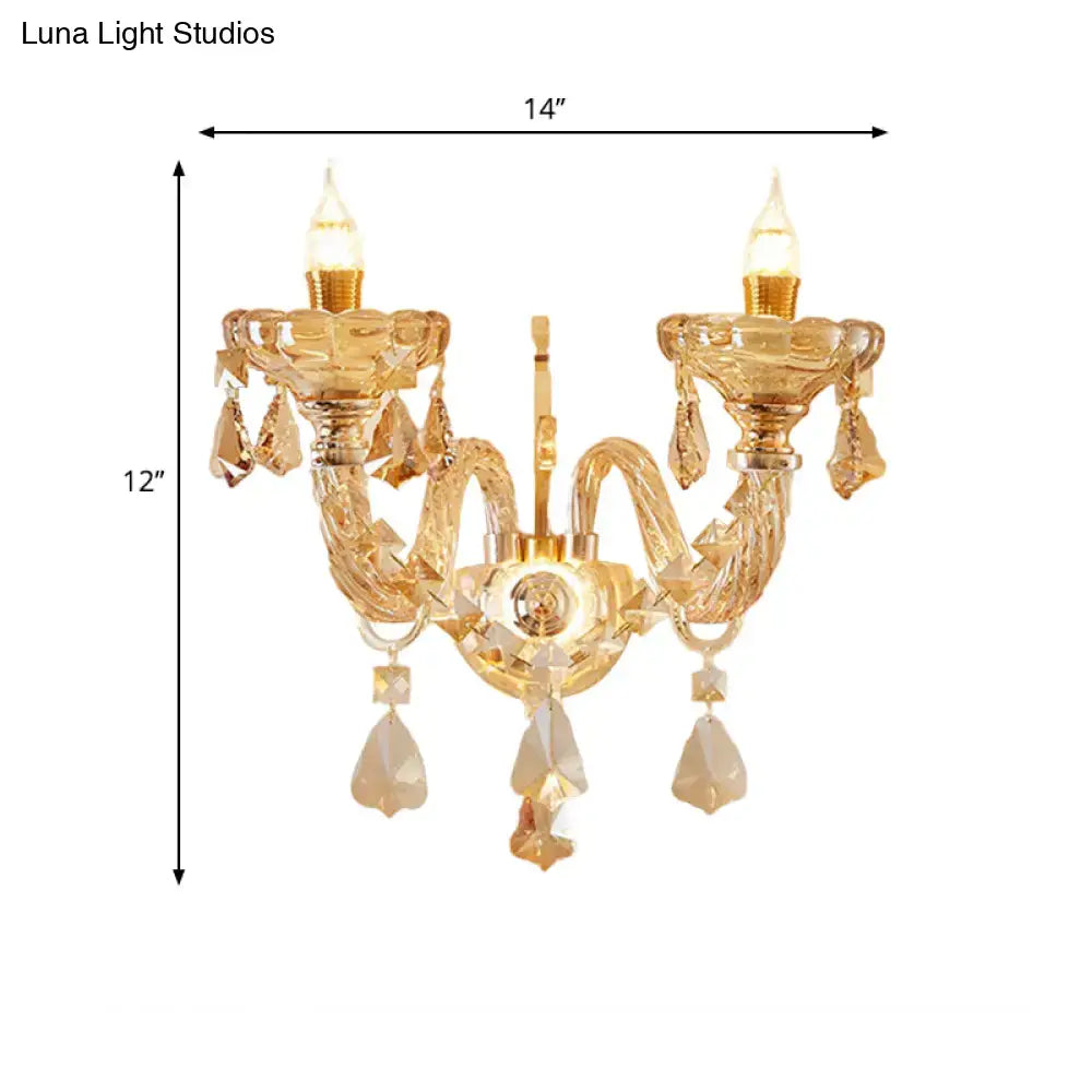 Modern gold crystal wall sconce inch fixture with two arms and dangling teardrop crystals for bedroom use